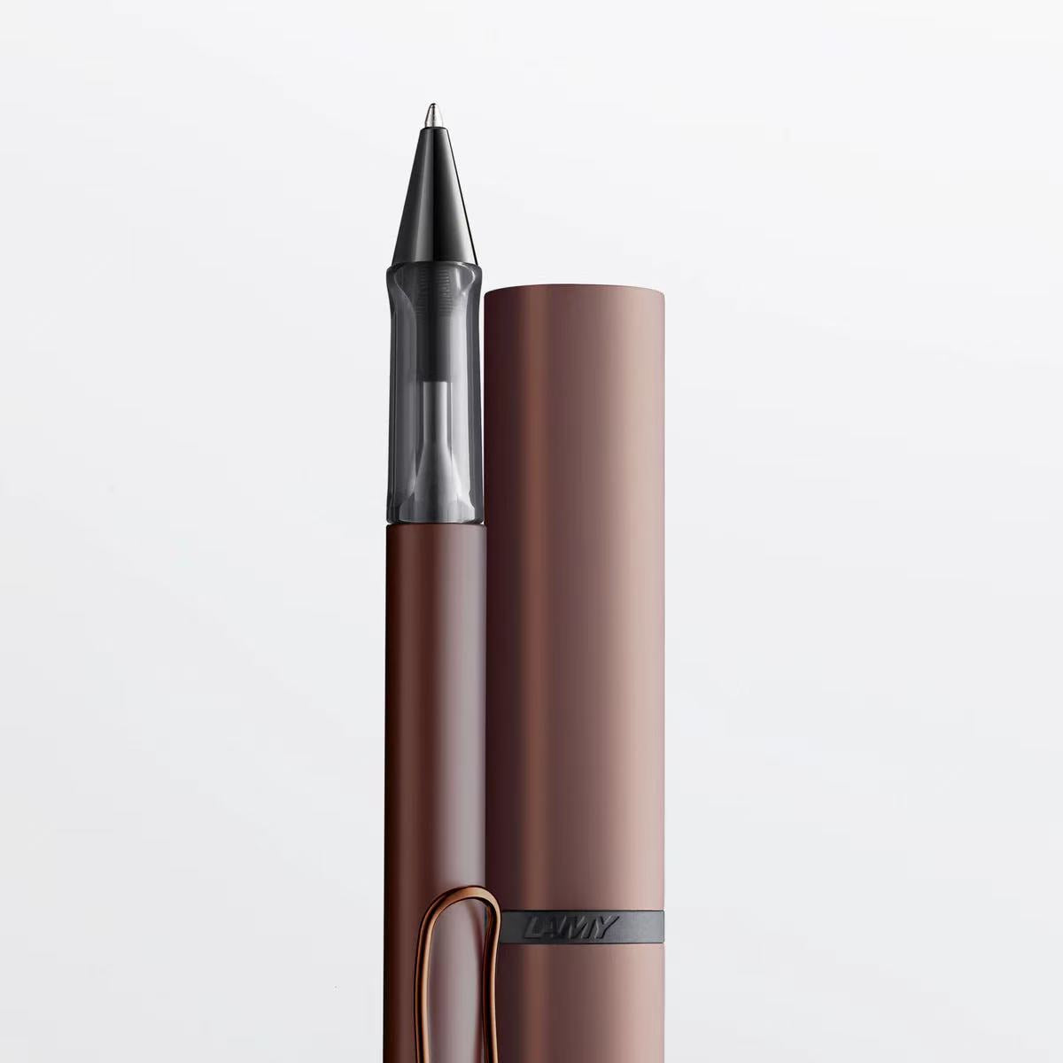 Brown pen with cap on a light gray background
