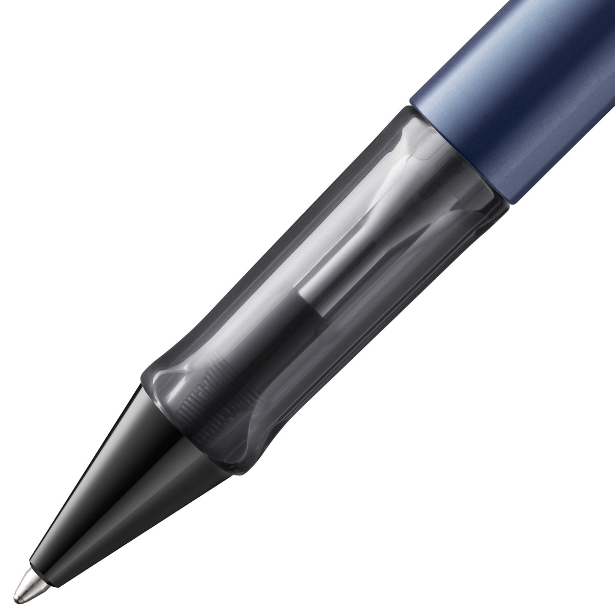Close-up of a retractable ballpoint pen showing the tip, transparent ink reservoir, and a dark blue cap on a white background.