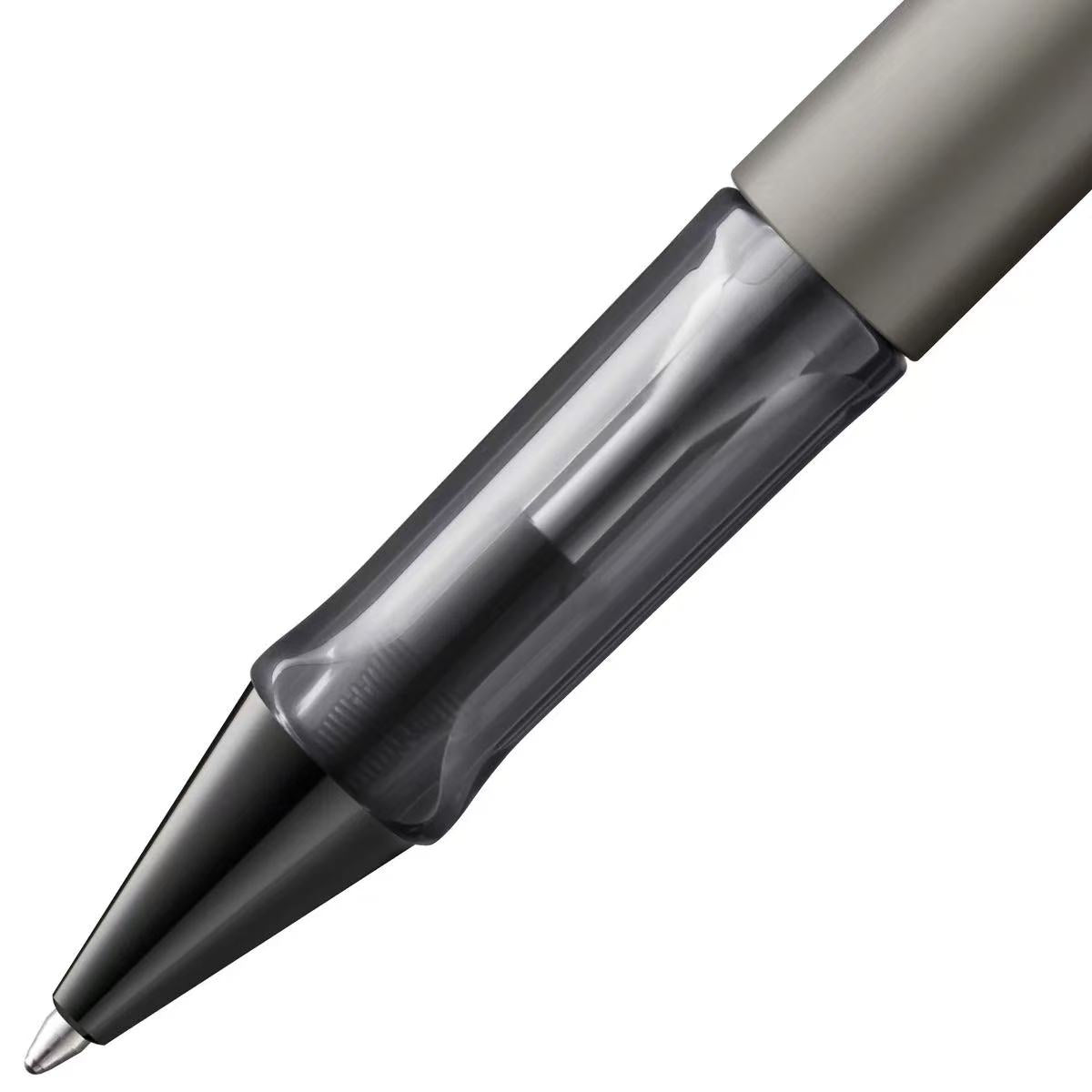 Close-up of a pen with a clear and metallic design on a white background